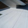 Elastomeric over rolled roofing